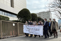 ▲原告の川崎栄子さん（80）らが東京地裁前で北朝鮮と金正恩国務委員長を糾弾する横断幕を掲げている。／崔銀京特派員 